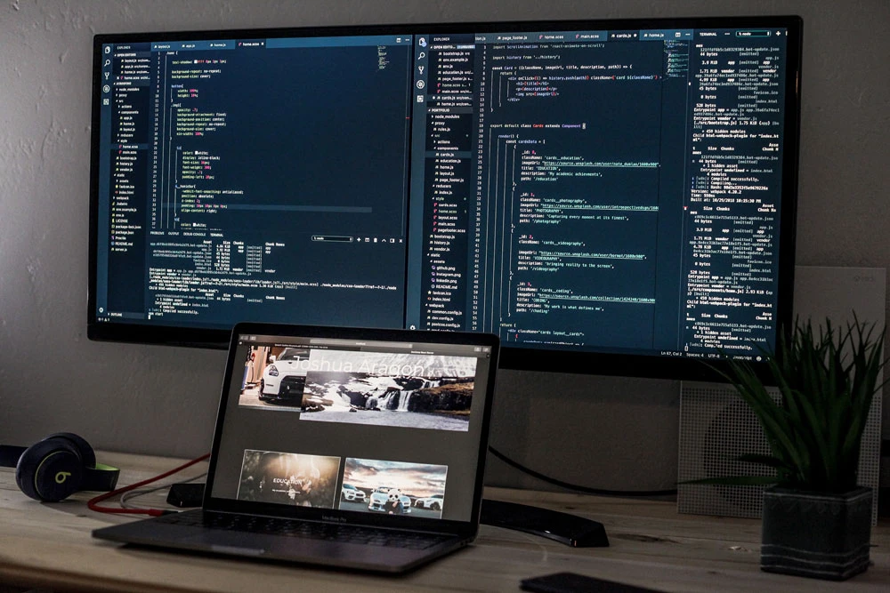 Developer workspace with source code across multiple monitors